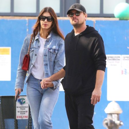 Camila and Leonardo holding each others hands